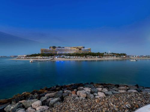 a resort on the shore of a body of water at Rixos The Palm Hotel & Suites - Ultra All Inclusive in Dubai