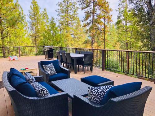 a deck with chairs and a table with a grill at Large Deck & Spa & Games & Vaulted Ceiling Cabin in Groveland