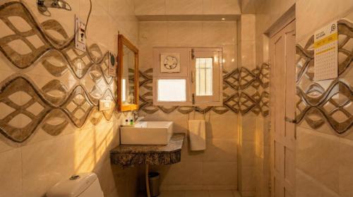 a bathroom with a sink and a mirror at Kalra Regency Shimla in Shimla