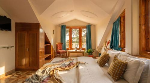a bedroom with a bed and a large window at Kalra Regency Shimla in Shimla