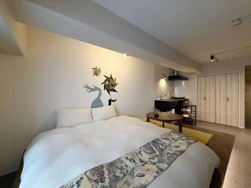 a bedroom with a large white bed in a room at Origaminn 303 by b hotel - 5 mins PeacePark in Hiroshima