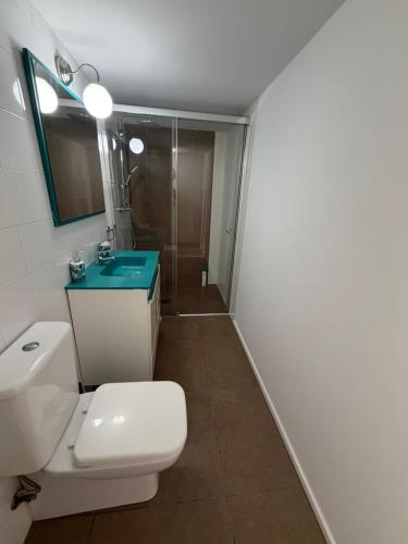 a bathroom with a toilet and a sink and a shower at Austria 03 in Lebrija