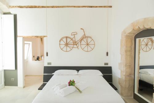 a bedroom with a bed with a bike on the wall at Monsignore Luxury Suite in Monopoli