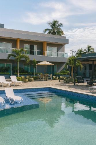 a building with a swimming pool next to a resort at Tibisay Hotel Boutique Morrocoy in Tucacas