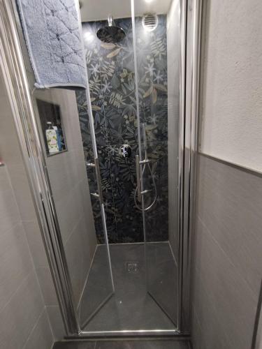 a shower with a glass door in a bathroom at Come a casa B&B in Montegrino Valtravaglia