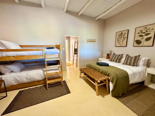 a bedroom with two bunk beds and a couch at Toorwater Spa in Uniondale