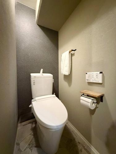 a bathroom with a white toilet in a room at Origaminn 603 by b hotel - 5 mins PeacePark in Hiroshima