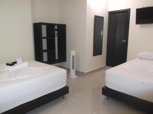 Säng eller sängar i ett rum på Hotel Monarca Putumayo