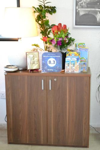 a table with a lamp and flowers on top of it at Marianna Hotel Apartments in Limassol