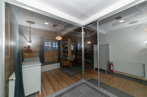 a living room with a glass wall at Smeštaj Iver in Mokra Gora