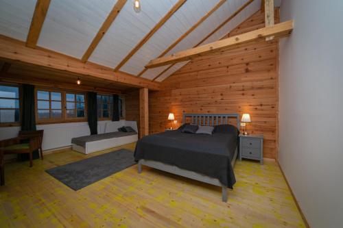 a bedroom with a bed in a wooden room at Smeštaj Iver in Mokra Gora