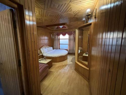 a small room with a bed and a window at New Amar Palace Shimla with Mountain View in Shimla
