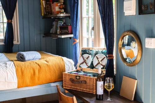 a bedroom with a bed and a table with a mirror at Peace in Piece in Redruth