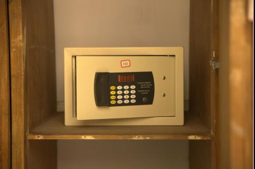 a microwave oven on a shelf in a room at Babylon Hotel & Serviced Apartment in Dhaka