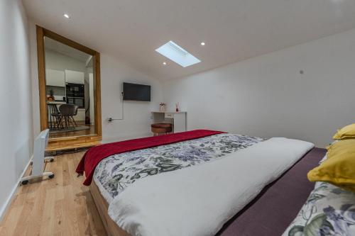 a bedroom with a large bed and a mirror at Apartman Draga in Varaždin