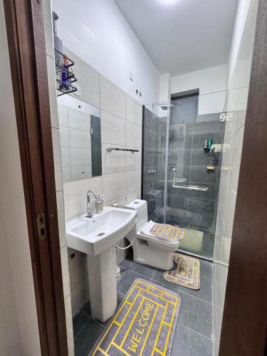 a bathroom with a sink and a toilet and a shower at Two bedroom, Nyali rd in Mombasa