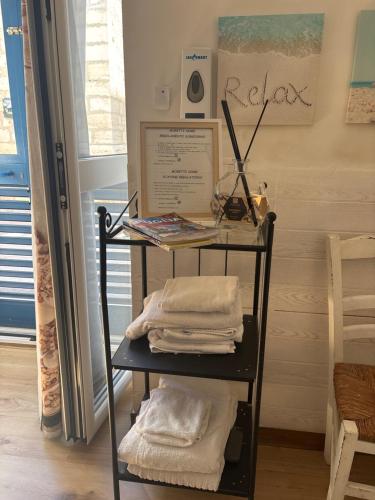 a towel rack with towels on it in a room at Moretti Home in Bari