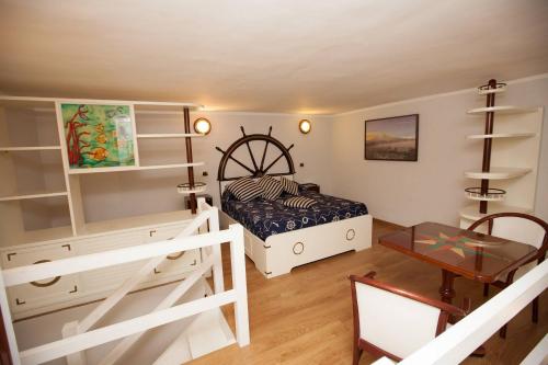 a bedroom with a bed and a desk and a table at Hotel Ausonia in Naples