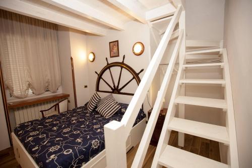 a bedroom with a bunk bed and a white staircase at Hotel Ausonia in Naples