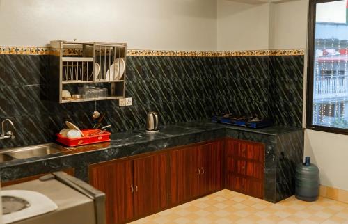 a kitchen with a sink and a counter top at Yangchen Home Hotel in Kathmandu