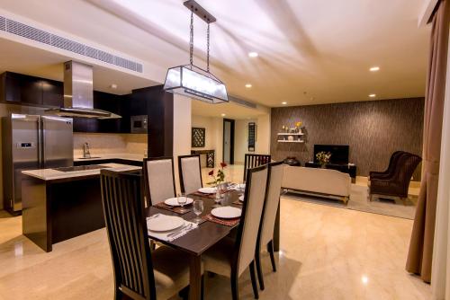 a dining room and kitchen with a table and chairs at Luxury Apartment at AYANA Residences in Jimbaran