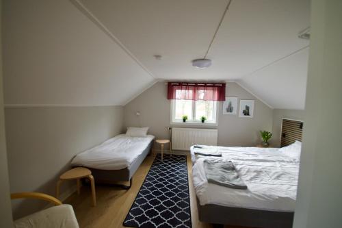 a bedroom with two beds and a window at Hagabergets Vandrarhem in Ullared