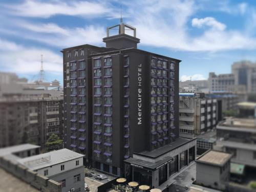 a black building with a tower on top of it at Mercure Xi'an Downtown in Xi'an