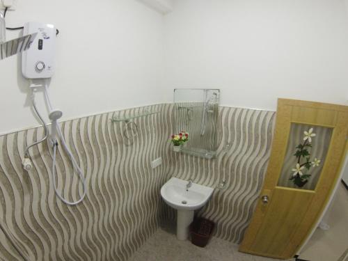 a bathroom with a sink and a shower and a toilet at Resort of Happiness in Mirissa