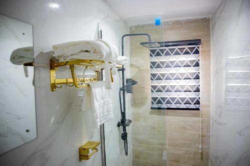 a shower stall in a bathroom with a shower at Dee Rocket Hotel & Lounge in Ibadan