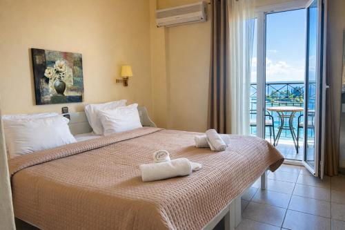a hotel room with a bed with towels on it at Aegli Hotel in Perama