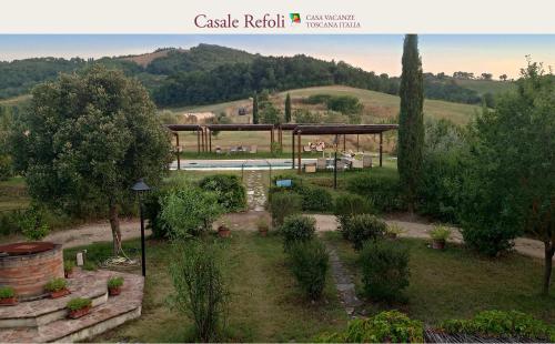 a view of a garden with a pavilion and a pool at Casale Refoli in Casole dʼElsa