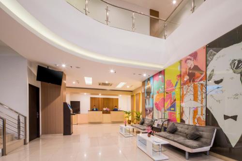 a lobby of a hospital with a large painting on the wall at Hotel 88 Grogol Jakarta By WH in Jakarta