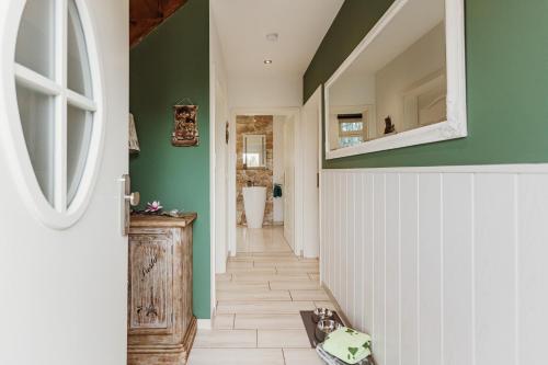 a hallway with green walls and a white and green door at HarzZeitRaum in Thale