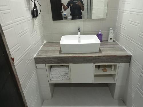 a person taking a picture of a bathroom sink at Kokomo Sunset Resort in Gazipur