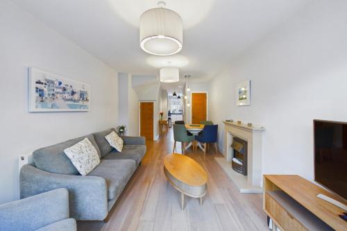 a living room with a couch and a table at Luxury 3-Bed house, Beach 300m, Sleeps 6, Parking in Newquay