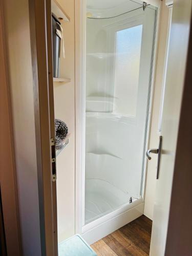a glass door to a shower in a closet at bungalow le TXOKO in Lit-et-Mixe