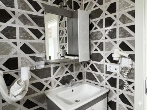 a bathroom with a sink and a mirror at Salinas Hotel in Gümbet