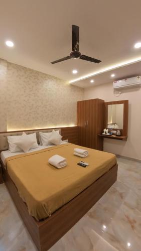 a bedroom with a large bed with a ceiling fan at UK Comforts in Bangalore