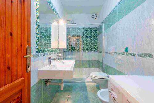 a bathroom with a sink and a toilet at A.I.R. Isola Rossa Borgo di Mare in Isola Rossa