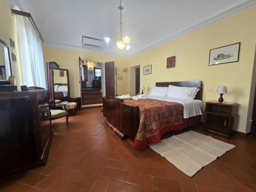 a bedroom with a large bed in a room at Il Terrazzino di Rosi, vivere in case nel borgo in Castiglione della Pescaia