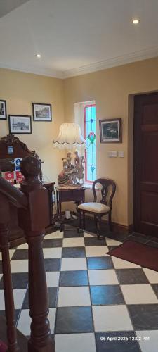 a living room with a table and chairs and a window at Deerpark Manor Bed and Breakfast in Swinford