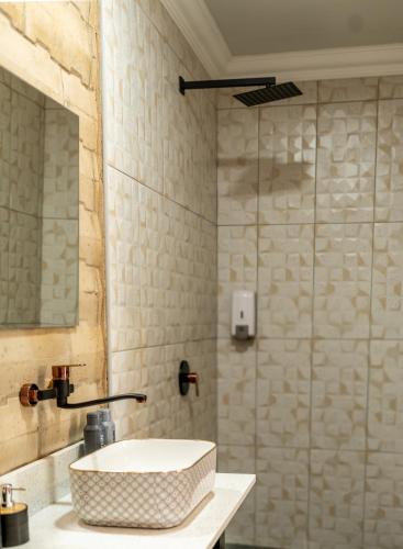 a bathroom with a sink and a shower at Purdy's Place in Louis Trichardt