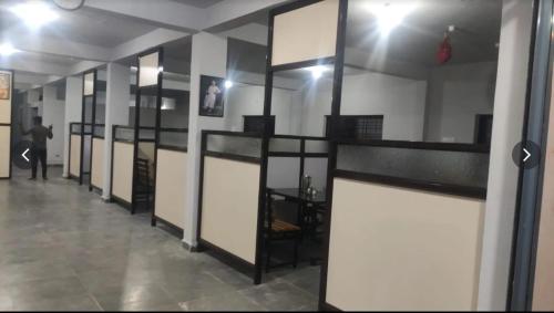 a room with a row of glass doors in a building at Salt Restaurant and Lodging in Navalgund