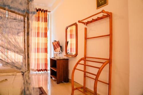 a room with a mirror and a wooden shelf at Lake Edge Resort in Hambantota
