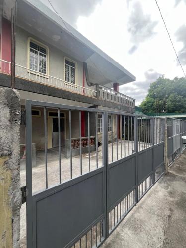 a fence in front of a house at E&E Residence in Locsin