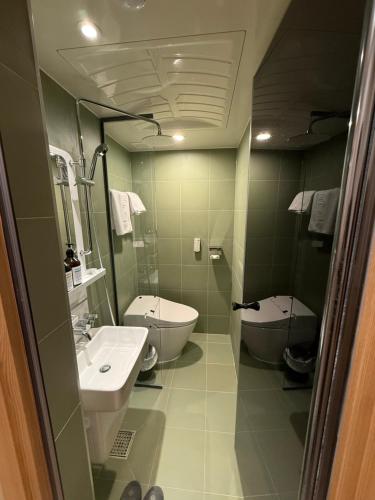 a bathroom with a sink and a toilet at Latree Hotel in Seoul