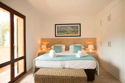a bedroom with a bed with blue and white pillows at Mallorca Soller Port Villa High end Balearics in Port de Soller