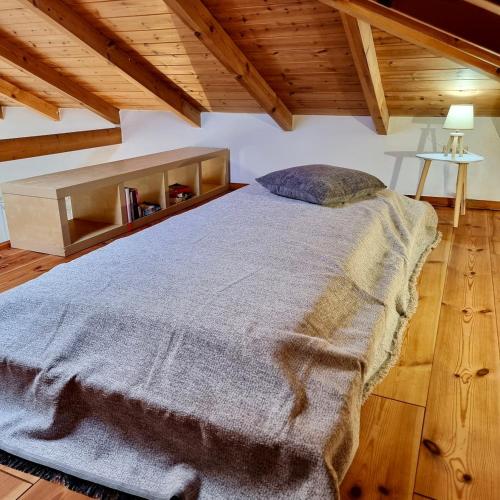 a large bed in a room with wooden ceilings at The House of Waves in Kotrónion
