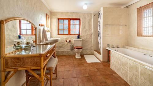 a bathroom with a tub and a toilet and a sink at Ramabanta Trading Post in Setleketseng