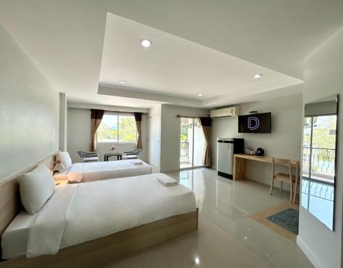a large bedroom with two beds and a kitchen at DD Boutique Resort in Ban Wat Pa